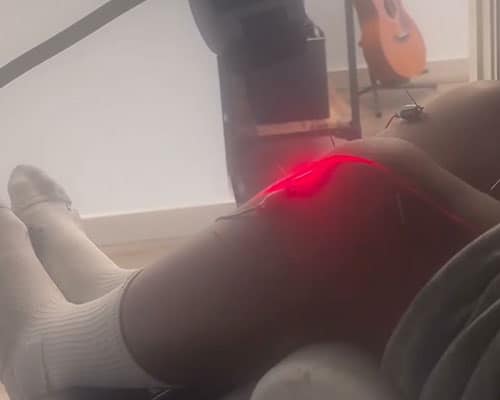 Laser therapy being performed on knee